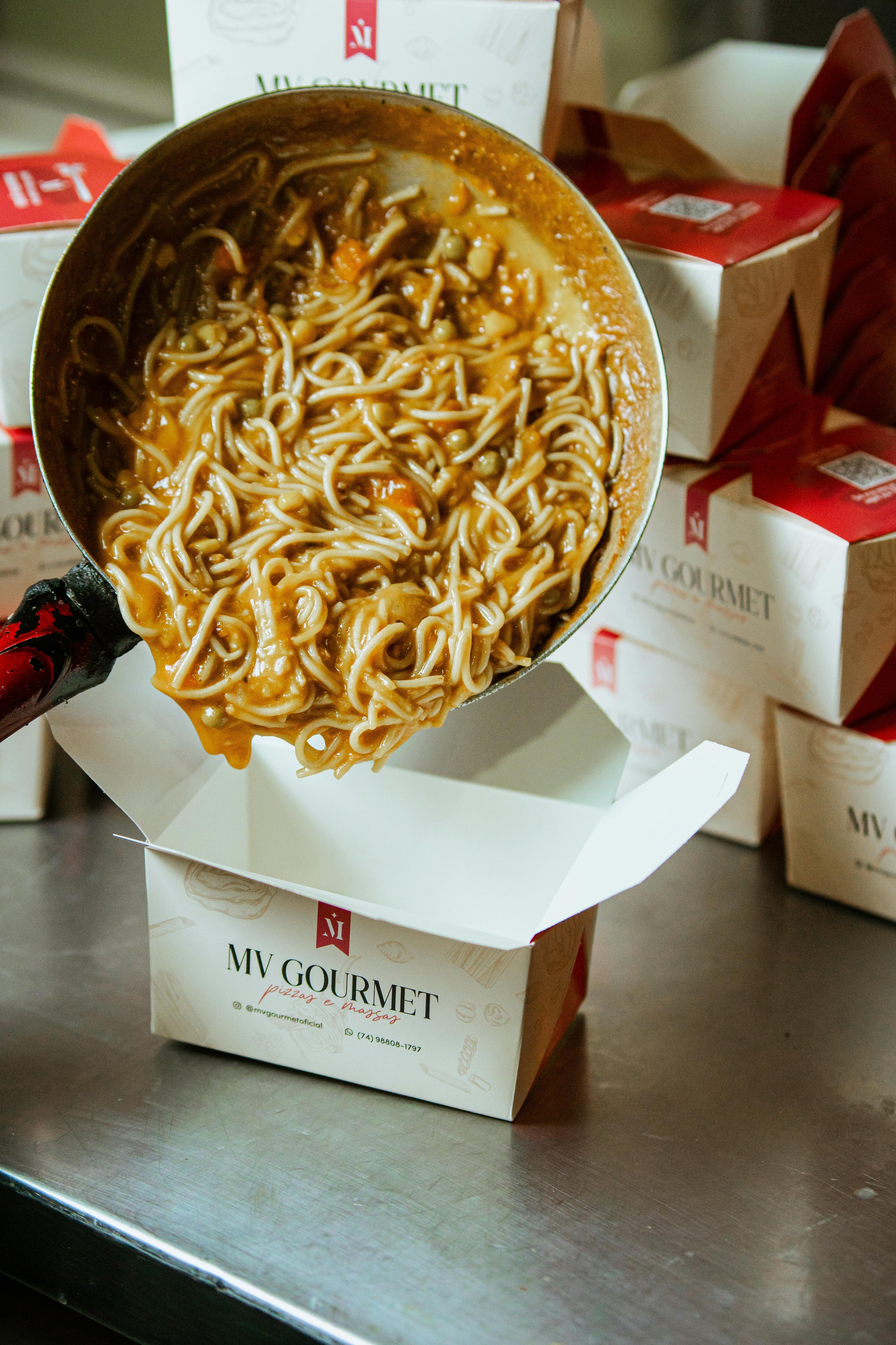 Beautiful Italian takeout containers with fresh pasta and sauce